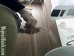 A young, attractive, dark-brown woman in the bathroom flashes her butt.